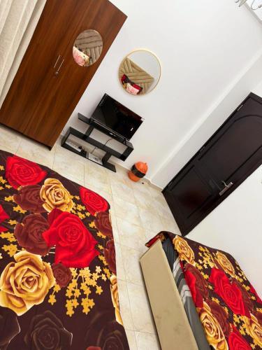 a bedroom with a bed with roses on it at Gorgeous Villa Rooms opposite to Mirdif City Center in Dubai