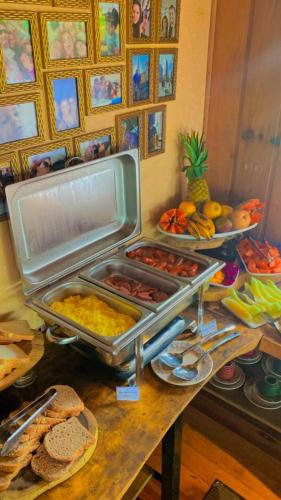 a buffet of food on a table with plates of food at Boutique Hotel dos Moinhos in Campos do Jordão
