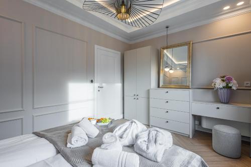 a bedroom with a bed with towels on it at Bałtyk Residence Międzyzdroje, BASEN, SAUNA Apartamenty 2,3,4 os z jacuzzi in Międzyzdroje