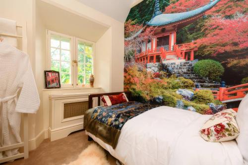 a bedroom with a large painting at Ladye Park in Liskeard