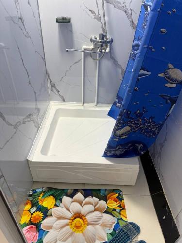 a bathroom with a sink with flowers on the floor at Хостел Ганга in Tashkent