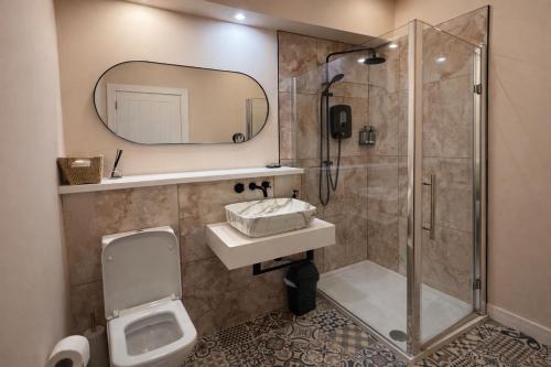a bathroom with a shower and a sink and a toilet at Inbhir Nis City Apartment in Inverness