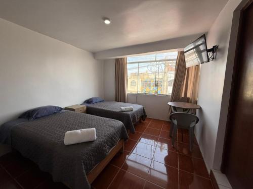 Giường trong phòng chung tại Hostal La Reserva - Pisco