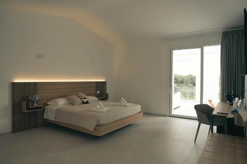 a bedroom with a bed and a large window at Villa Sanarica in Taranto