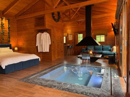 una camera da letto con vasca al centro di una stanza di Cave Chalet - Chalet for Two a Eptalofos