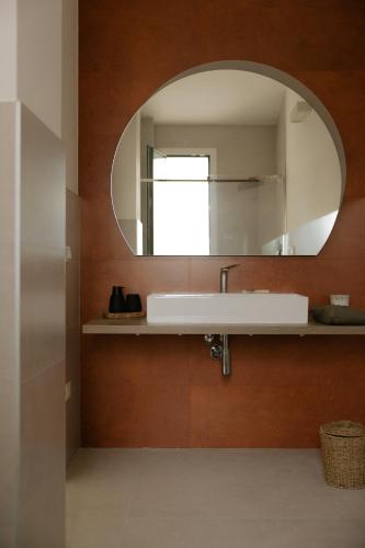 a bathroom with a sink and a mirror at Villa Sanarica in Taranto