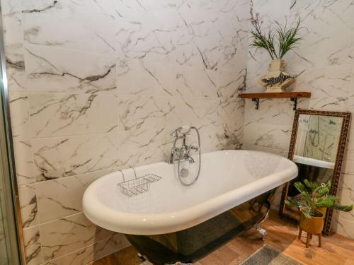 a bathroom with a sink and a marble wall at Baywatch St David's View in Lynton
