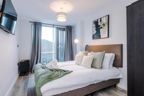 a bedroom with a large bed and a large window at Birmingham City centre, Pool table, Spacious in Birmingham
