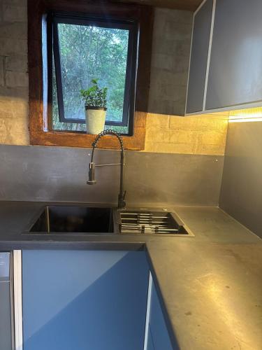 a kitchen with a sink and a window at Bosch Rest in Pretoria