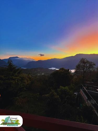 a view of a sunset from a balcony at Chalet Maranatha Vista Única Represa de Chivor in Macanal