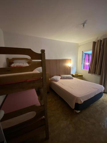 En eller flere senge i et værelse på Pousada da Marli