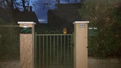 a gate in front of a house at night at Berne &Michel in Montfavet