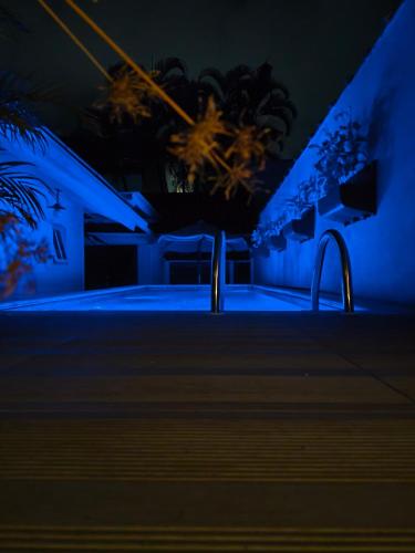 a building with blue lights in the dark at Pousada Hospedaria215 in Juquei