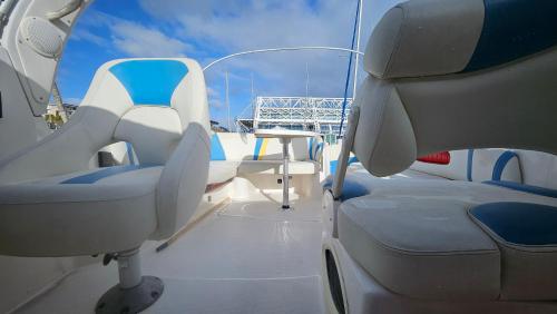 a boat with white seats and a table on it at Lisboa Expo Barco Lancha H33 in Lisbon