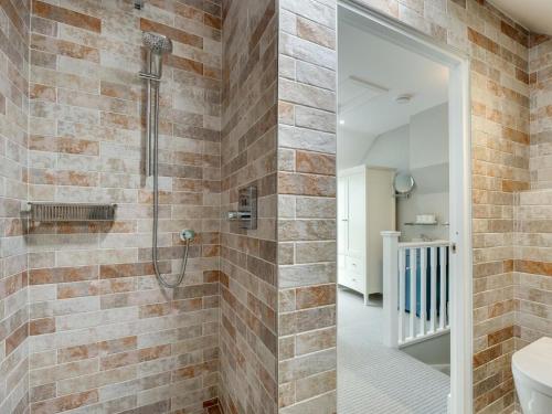 a bathroom with a walk in shower next to a toilet at 3 Bed in Beadnell oc-cn113 in Beadnell