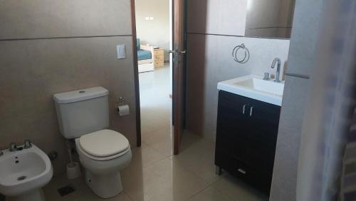 a bathroom with a toilet and a sink at dpto SanLuis in Valeria del Mar