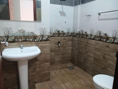 a bathroom with a sink and a toilet at The Grand Villa Malabe in Malabe
