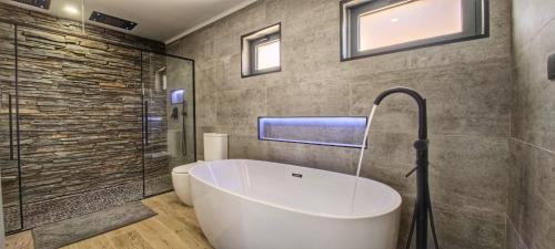 a bathroom with a bath tub and a toilet at The View House in Albufeira