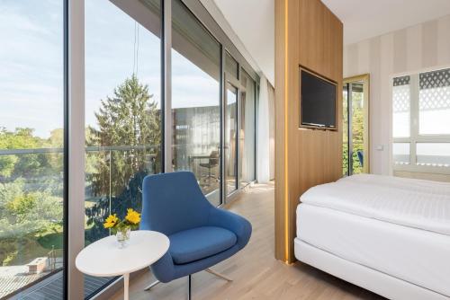 Giường trong phòng chung tại NH Graz City