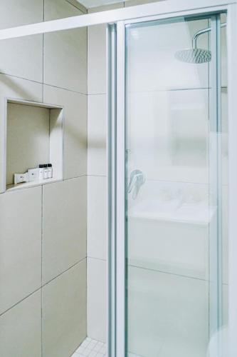 a shower with a glass door in a bathroom at Modern Nest in Sandton