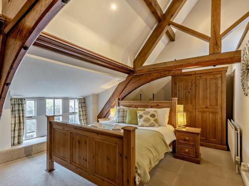 a bedroom with a large bed with a wooden frame at 2 Bed in Ambleside oc-95914 in Hawkshead