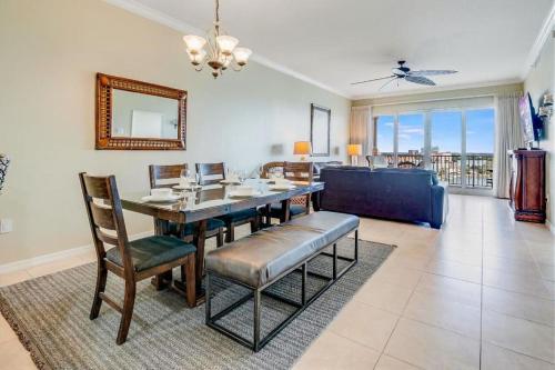 a dining room with a table and a couch at Luxury 5 Star Waterfront Condo 3 Bdr 2 Bath Pool Hot-Tub Panoramic Gulf and Intracoastal Waterway Views in Clearwater Beach