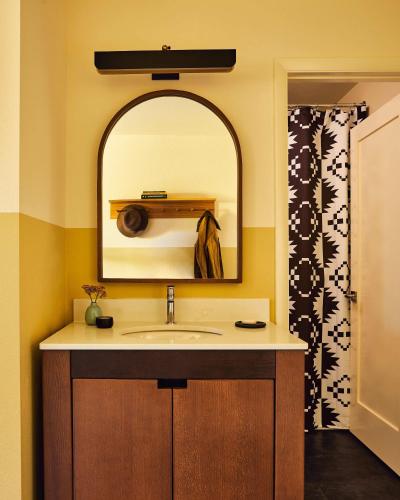 a bathroom with a sink and a mirror at Wandering Buffalo in Bozeman