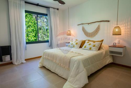 En eller flere senge i et værelse på Casa Calma Cariló