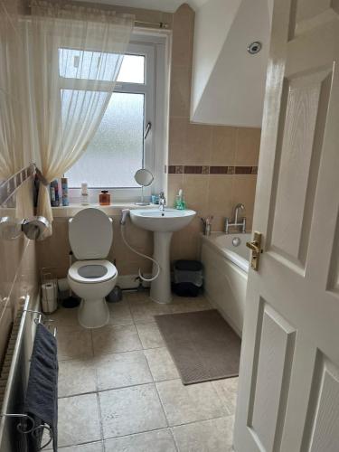 een badkamer met toilet, wastafel en bad bij Rowan in Bellshill