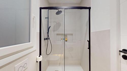 a shower with a glass door in a bathroom at Bilbao City Center in Bilbao