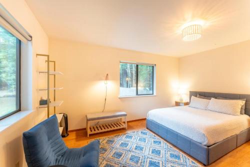 a bedroom with a bed and a chair at Serenity Grove in Fort Bragg