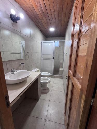 a bathroom with a sink and a toilet and a shower at Alojamiento La Mamu 1 in Paso de la Patria