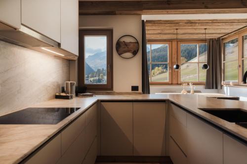 a kitchen with a view of a mountain at Ciasa Bel Marin in La Villa