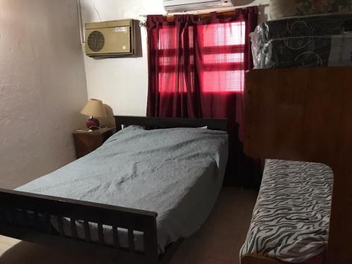 a small bedroom with a bed and a window at Alojamiento La Mamu 1 in Paso de la Patria