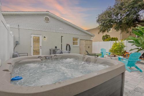 a hot tub in the backyard of a house at Duneside Bliss - Steps to the Ocean & Mins to DT in St. Augustine