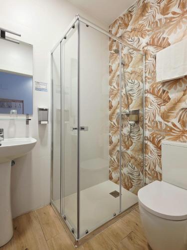 a bathroom with a shower and a toilet at Bilbao ROOMS & KITCHEN Altube in Bilbao
