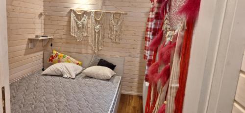 a bed with two pillows in a room at Bambolina in Marche-en-Famenne
