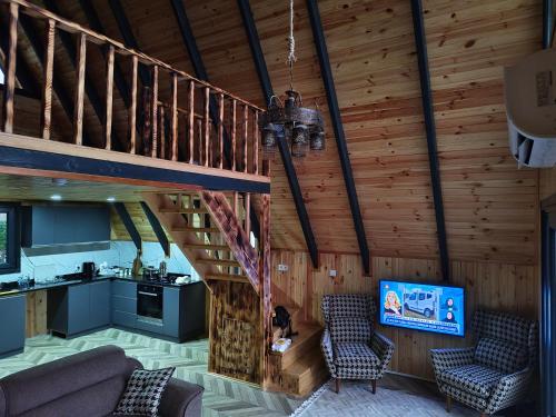 a living room with a staircase in a house at YAKUT bungalow in Akyazı