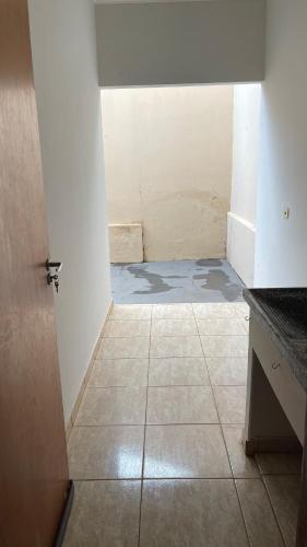 an empty room with a door and a tile floor at Casa Gêmeas 2 in Andradina