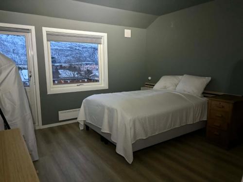 a bedroom with a large bed and a window at Hogne's house in Tromsø