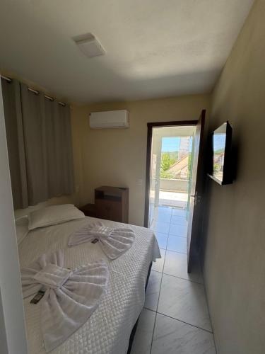 Giường trong phòng chung tại Residencial Lara 10