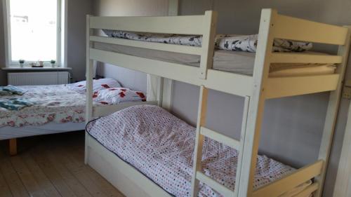 a bedroom with two bunk beds and a bed at Rundvejen Guest House in Aalborg