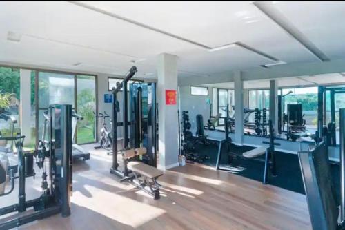 une salle de sport avec des tapis de course et des machines dans une pièce dans l'établissement Apartamento em Resort no Litoral sul, à Parnamirim