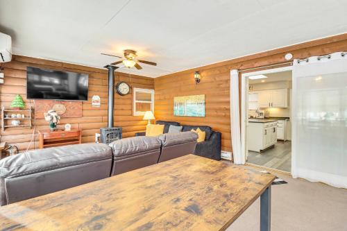 a living room with a couch and a table at Hike and Ski Log Cabin in East Stroudsburg! in East Stroudsburg