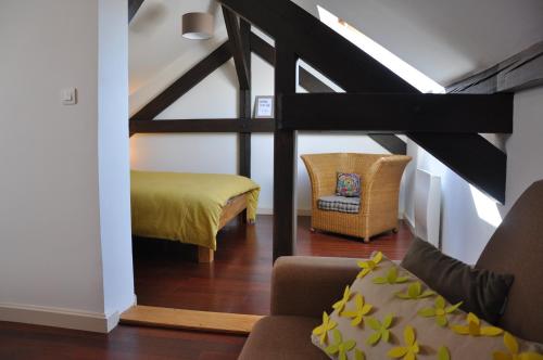 a living room with a bed and a couch and a chair at L'écluse de Saverne in Saverne