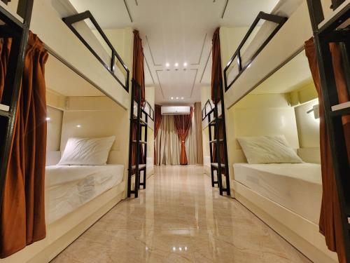 a hallway with two beds in a room at Hana Stay Hostel in Luxor