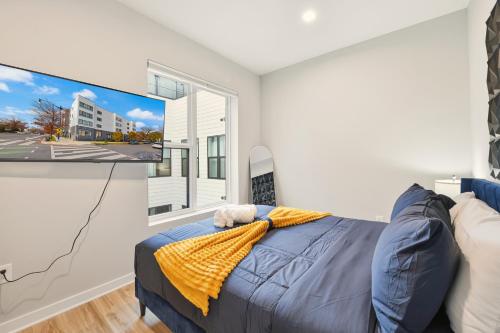 a bedroom with a bed and a flat screen tv at Union market Lux condo in Washington, D.C.