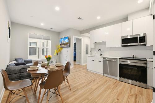 a kitchen and living room with a table and chairs at Union market Lux condo in Washington, D.C.