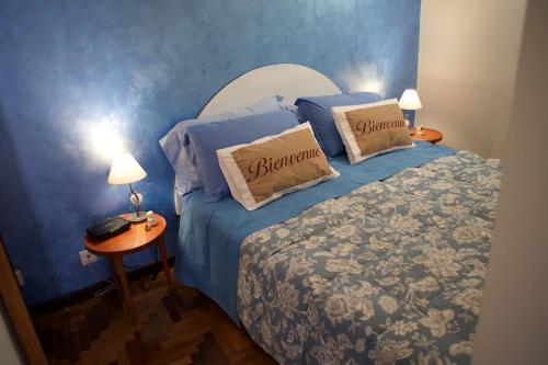 a blue bedroom with a bed with two pillows on it at La Casetta di Zio Mario in Rome