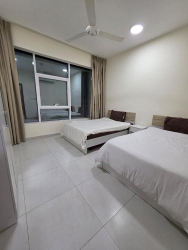 a hotel room with two beds and a window at Opera43 Spacious & Central in Ghubrah
